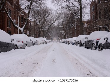 A Neighborhood Street In Chicago Is Covered With Snow After A Blizzard.