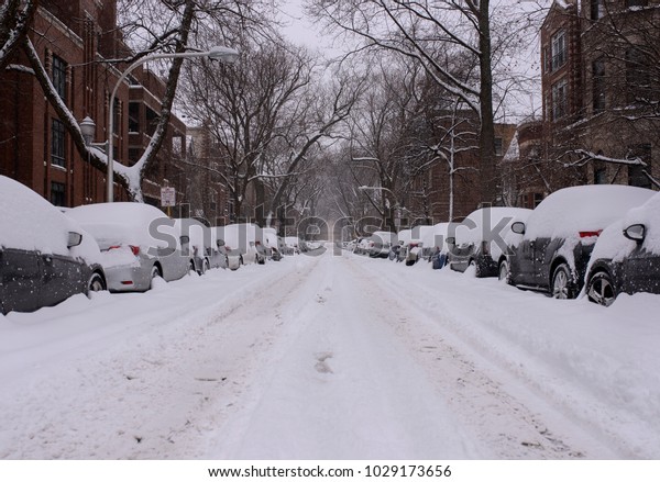 A neighborhood street in Chicago is covered\
with snow after a blizzard.