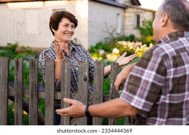 neighbors man and woman chatting near the - Powered by Shutterstock