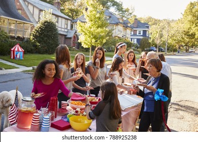 Neighbours helping themselves to food at a block party