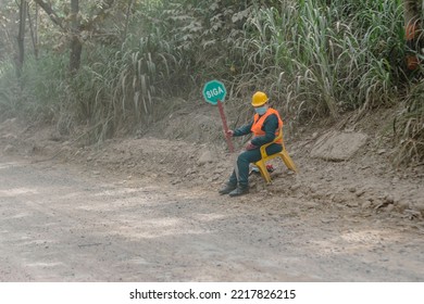 Neiva, Huila, Colombia, October 20 2022 : Road Construction Worker (woman) Showing A Sign On A Dusty Earth Road Saying Siga, Which Means, Keep On In English. Work In Progress On A Road.