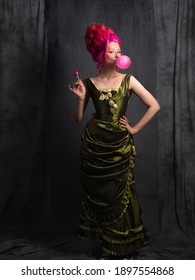 Neo Kitsch, Young Woman In Baroque Style, Costume And High Hairstyle In Historical Style And Modern Elements. Pink Hair And A Bubble Of Pink Gum, Funny Contrast Of Old And Modern, Portrait