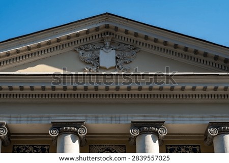 Neoclassical Architecture Facade With Ionic Columns, Ornamental Pediment and Decorative Cornice.