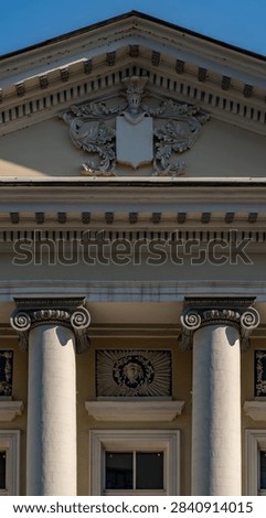 Neoclassical Architecture Facade With Ionic Columns, Ornamental Pediment and Decorative Cornice.