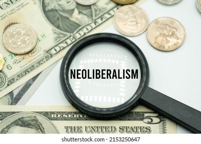Neoliberalism.Magnifying glass showing the words.Background of banknotes and coins.basic concepts of finance.Business theme.Financial terms. - Shutterstock ID 2153250647