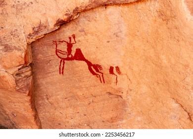 Neolithic rock art. Rock painting of a camel with rider. Tadrart Rouge. Tassili N'Ajjer National Park. Sahara Algerian Desert. Illizi Province, Djanet, Algeria, Africa    

 - Shutterstock ID 2253456217