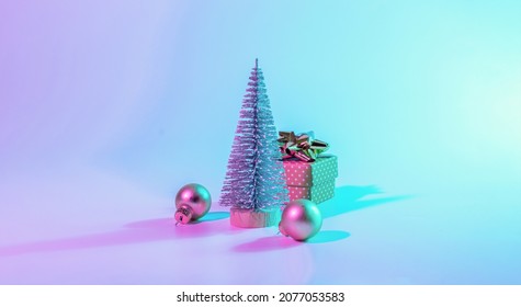 Neon Christmas winter background  Minimal abstract tree  xmas gift box  Holiday decoration bauble ball neon gradient backdrop  Happy new year copy space