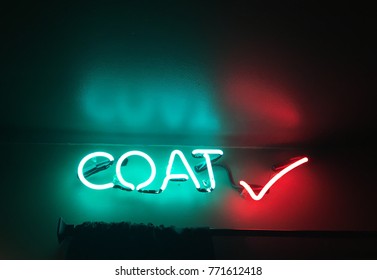 Neon Coat Check Sign In A Dark Entrance To A Nightclub Or Theatre.