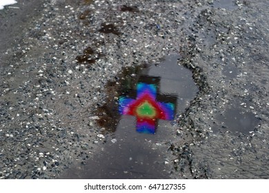 Neon cross, pharmacy sign, luminous, with burning lights in the form of a heart reflected in a puddle on the asphalt in rainy weather. For wallpaper, advertising, design, covers, background, textures. - Powered by Shutterstock