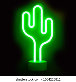 Neon Green Cactus LED Lamp On Black Background.