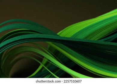 Neon green color strip wave curve paper line on black. Abstract texture background.