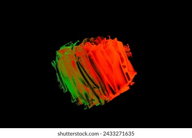Neon green orange color paint splotches on black background. Isolated design element
