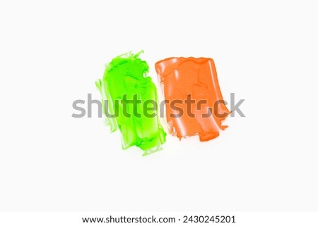 Neon green orange color paint splotches on white background. Isolated design element
