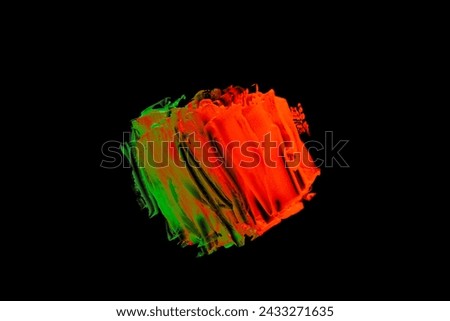 Neon green orange color paint splotches on black background. Isolated design element