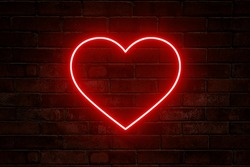 Neon Heart With A Glow On The Background Of A Dark Brick Wall. Neon Sign.