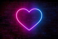 Neon Heart With A Glow On The Background Of A Dark Brick Wall. Neon Sign Pink And Blue.
