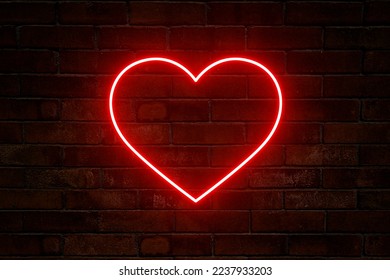Neon heart with a glow on the background of a dark brick wall. Neon sign.
