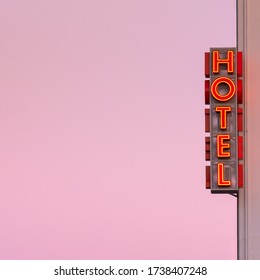 Neon hotel sign on the building corner with pink sunset sky at background. Empty copy space for inscription. Vintage neon sign. - Powered by Shutterstock