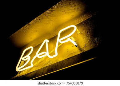 Neon Inscription BAR On The Wall. Neon Inscription BAR In Different Colors. Multicolored Neon Inscription BAR On Dark Background