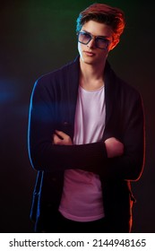 Neon Light Portrait Of Handsome Male Model With Dark Medium Length Hair, Hairstyle, Wear Sunglasses.