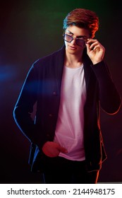 Neon Light Portrait Of Handsome Male Model With Dark Medium Length Hair, Hairstyle, Wear Sunglasses.