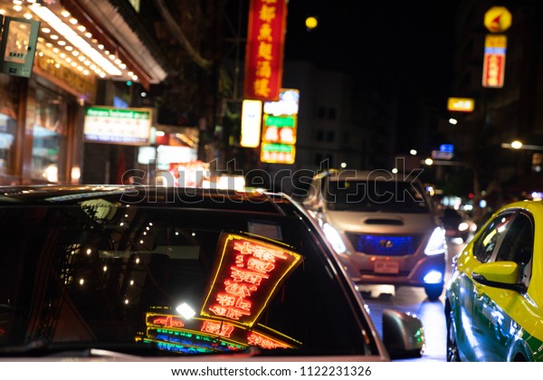 neon light signs\
reflect on windscreen of car in Yaowarat road at night in\
Chainatown,Bangkok\
:05/05/2018