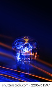 Neon Light Skull On A Dark Background. Halloween Background. Futuristic Light Lines, Bokeh.