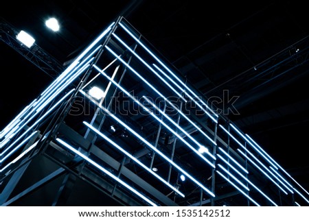 Neon lighting decoration on modern architecture detail of metal structure. Metal frame construction structure with Neon light 