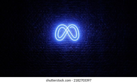 Neon Meta logo with brick wall background. Shiny neon meta logo in dark area. Facebook new logo. Neon meta icon.