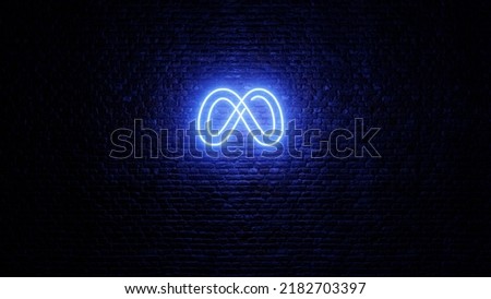 Neon Meta logo with brick wall background. Shiny neon meta logo in dark area. Facebook new logo. Neon meta icon.