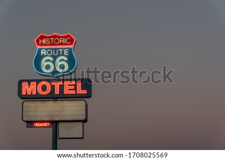 Neon motel sign on Route 66 in the evening.