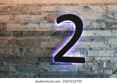 Neon number 2 against a brick wall - Powered by Shutterstock