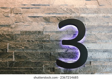 Neon number 3 against a brick wall - Powered by Shutterstock