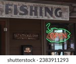 Neon Open Sign in Window of Rural Bait and Tackle Shop 