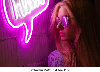 Neon Portrait. Blonde Girl With Glasses Looking To Light