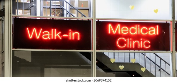 Neon Red Fluorescent Sign At A Downtown Dr's Office. Signs Indicate Patients Can 