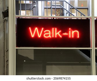 Neon Red Fluorescent Sign At A Downtown Dr's Office. Signs Indicate Patients Can 