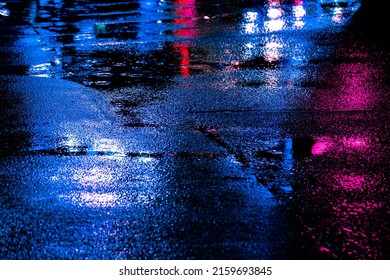 Neon reflection from street asphalt with pedestrian walking by. Futuristic city and cyberpunk concept. - Powered by Shutterstock