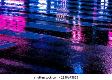 Neon reflection from street asphalt with pedestrian walking by. Futuristic city and cyberpunk concept. - Powered by Shutterstock