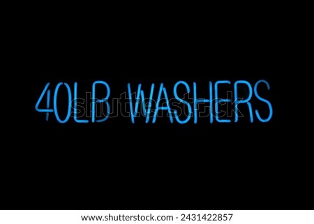 Neon Sign. Neon Sign in a Laundry Mat. Glowing Neon. 40 LB Washers. Neon Lettering. 40 Pound Washers Sign. Set of informational signs. Night bright signboard, Glowing light banner. Glowing Sign. Gas. 