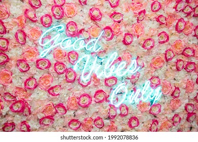 Neon sign saying "only good vibes" in bright color, on a background of colorful fake flowers. - Powered by Shutterstock - Get 15% off with code: PIKWIZARD15