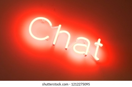 Neon sign - Shining over a white wall - Chat