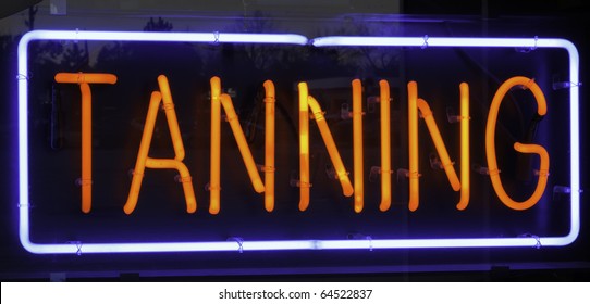 Neon Sign In Window Of Tanning Salon