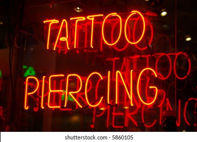 Neon Sign In The Window Of A Tattoo Parlor In New York City