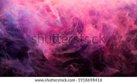 Neon smoke. Colorful abstract background. Paint in water splash. Spiritual aura. Glowing bright magenta pink purple steam blend on dark.