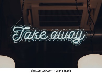 Neon Tube Light Take Away Sign On A Window Of A Restaurant In London, UK.