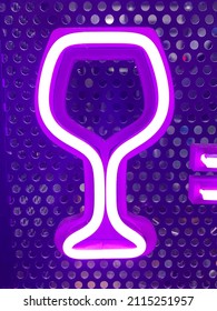 Neon Wine Glass Shaped Sign Glowing In The Window Of A Bar