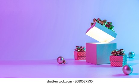 Neon xmas winter background  Open Christmas gift box and shine lights  minimal tree  Holiday decoration bauble ball neon abstract gradient backdrop  Happy new year copy space