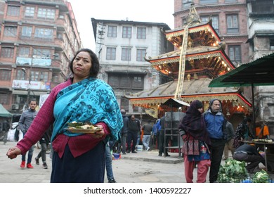 Nepal, Kathmandu, Ason district, 17 December 2018. Nepalese woman and beautiful temple