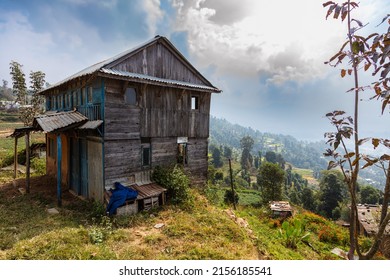 Nepal - October 28, 2021: Old Nepalese wooden house in the mountains around Kathmandu Valley. Wooden house on a mountain slope with a view of the valley. Rundown looking house in Nepal